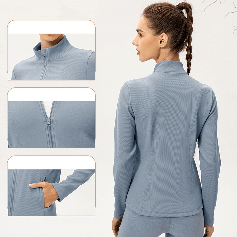 Back view of woman in light blue sports jacket with fleece-lined zipper and thumb holes, highlighting high collar and slim fit design.